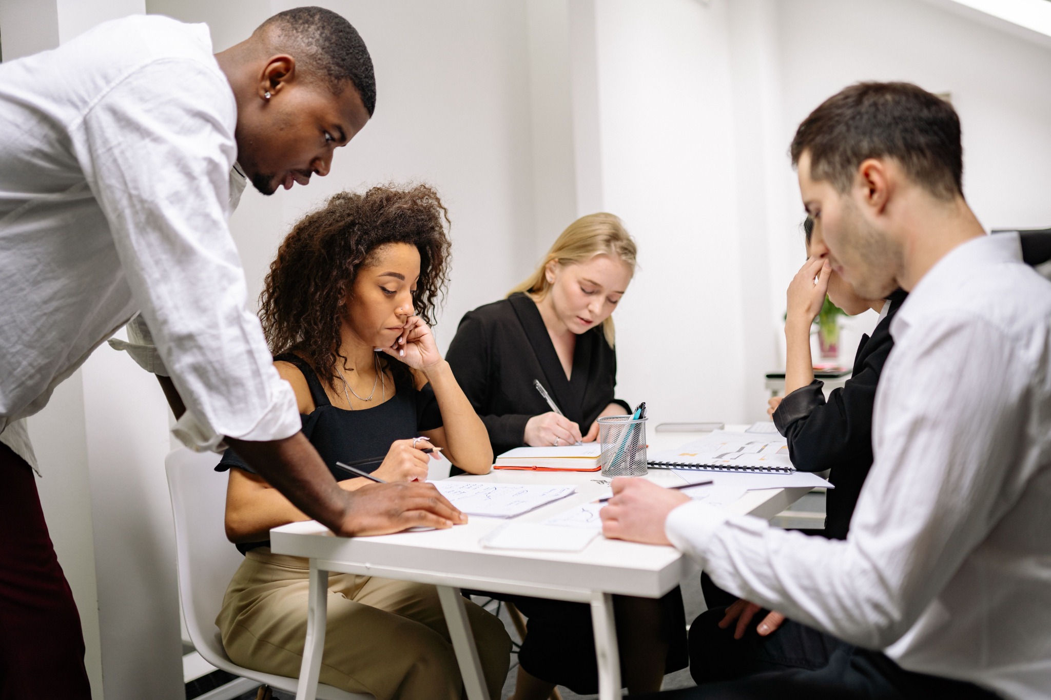 A project team working together around a table during a collaborative workshop
